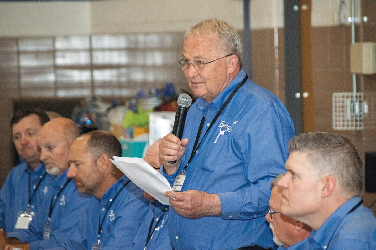 Director in blue shirt holding microphone