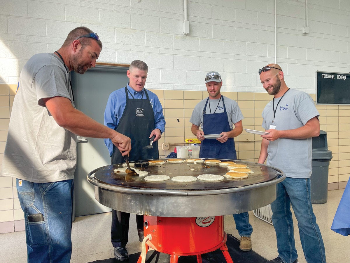 Men cooking pancakes